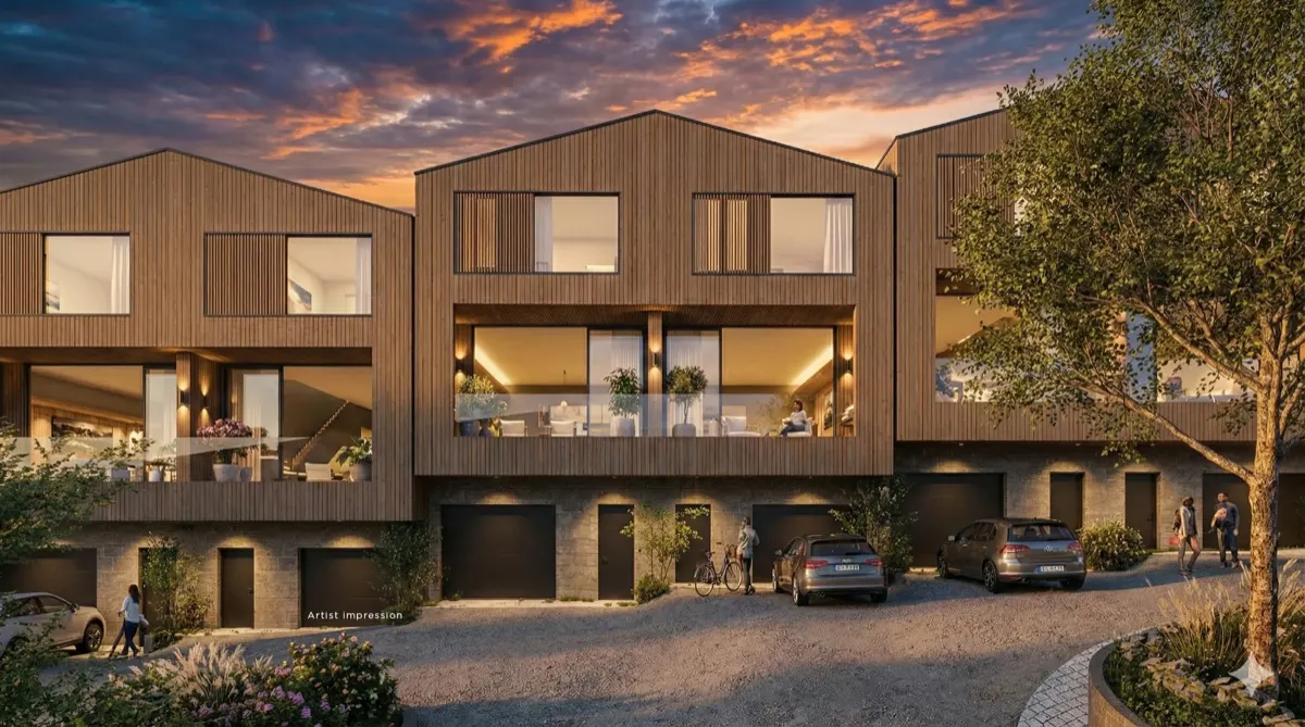 Terrace residences at dusk with lit interiors